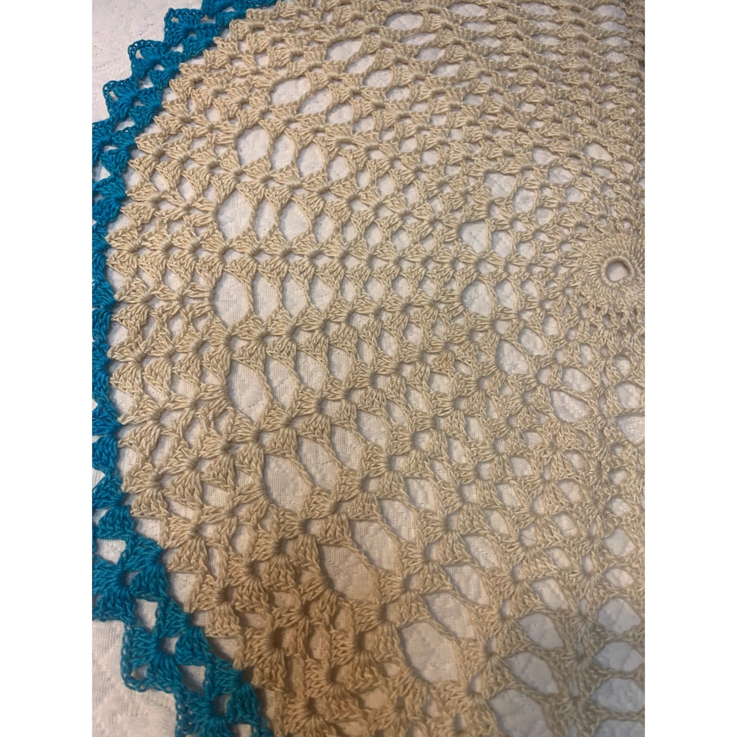 Vintage hand crocheted doily with aqua edge